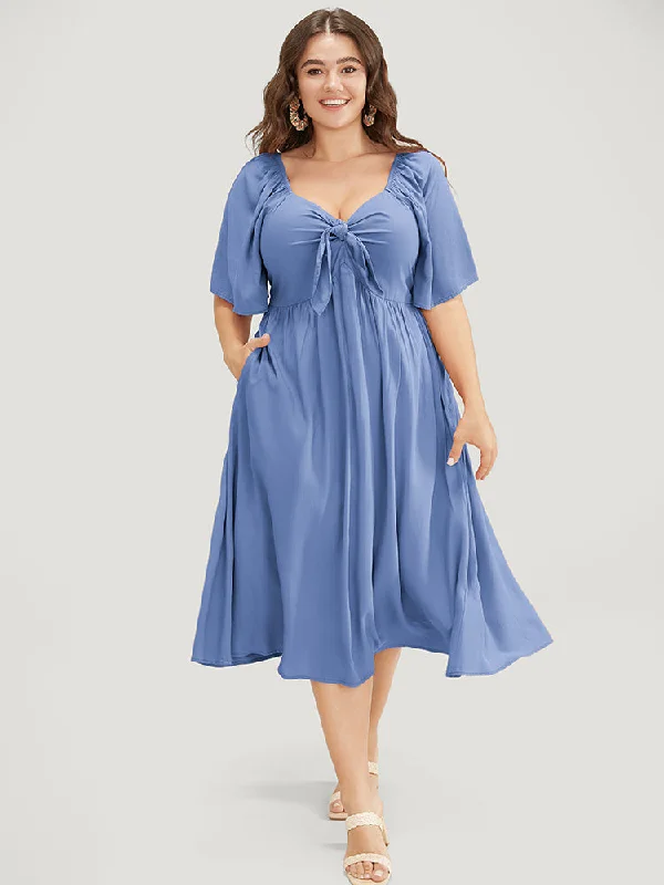 Plus size dresses featuring quilted textures add depth -Solid V Neck Ruched Knotted Pocket Ruffle Hem Dress