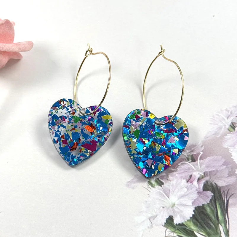 A pair of blue glitter love earrings