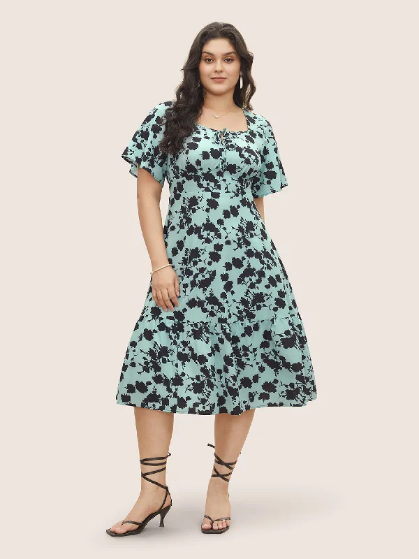 Plus size dresses with unique necklines add flair -Silhouette Floral Print Knot Neck Flutter Hem Dress