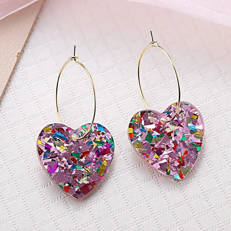 A pair of pink glitter love earrings